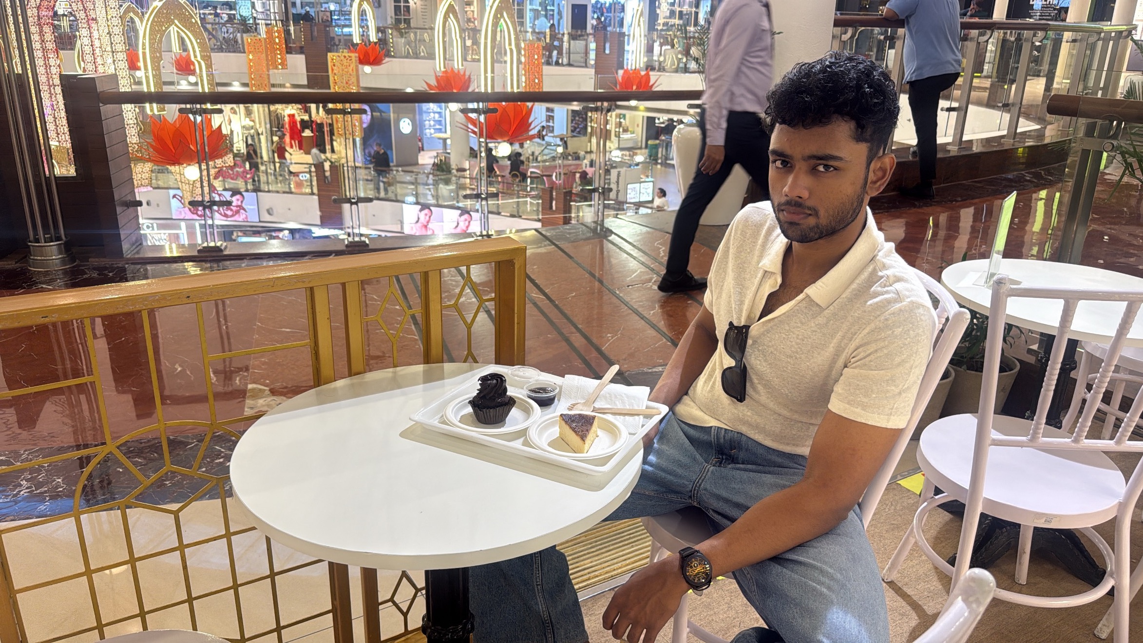 Sohan at the cafe with dessert, in a corrected landscape photo